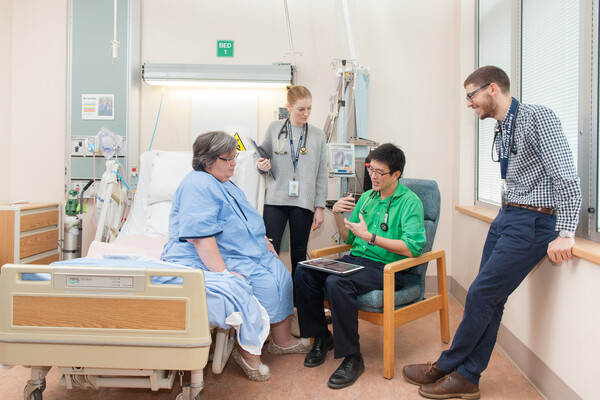 Medical students talking with a patient